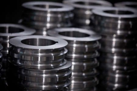 many piles of metallic shiny gears and spare parts for equipment with abstract blurred background, nobodyの写真素材