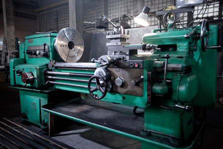 closeup of metallic lathe working against factory industrial interior background, nobodyの写真素材
