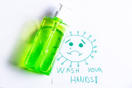 Drawing by a child of the coronavirus so you remember to wash your hands well with a bottle of disinfectant soap. Wash your hands.の写真素材