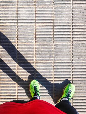 Person going out for sport. Person in sportswear going outdoors to exercise. Running in the city.の写真素材