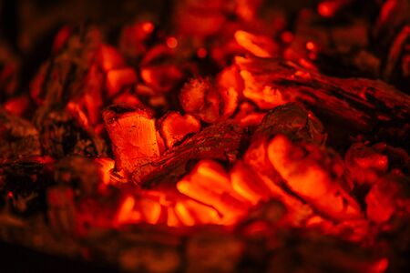 Burning orange embers from a fireplace to make grilled meat.の写真素材
