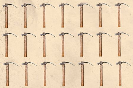 Mosaic of some wooden hoes on a textured pastel background. Gardening tools.の写真素材