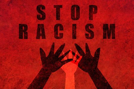 Stop racism. Black and white hands united in the center asking for equality with a powerful message that says stop racism.の写真素材