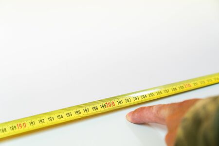 Measuring with a ruler the safe distance between school tables so that students maintain a safe distance of two meters.の写真素材