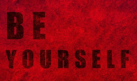 Be yourself. Design with a powerful optimistic message on a red textured background.の写真素材
