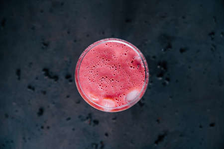 Fresh strawberry smoothie on old retro background. Top view with copy space. Healthy milkshake eating concept.の写真素材