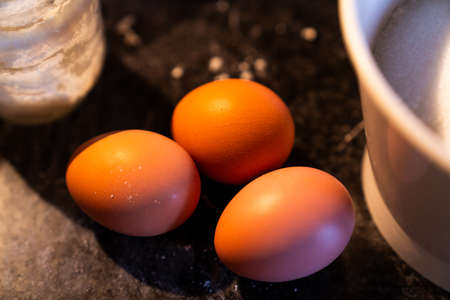Ecological eggs on top of the kitchen marble to make a homemade cake.の写真素材