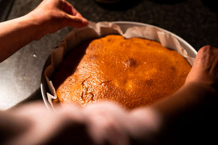 Freshly baked hot cake on top of the kitchen marble. Preparing a homemade cake at home in the...