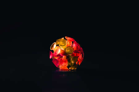 Glowing red virus in the dark. Covid 19 coronavirus illuminated on black background.の写真素材