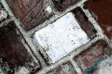 Closeup of vintage stones wall texture. Background of old bricks with brown and white tones. Weathered stain old brick wall.の写真素材