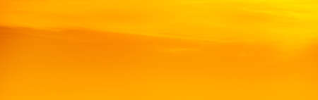 Orange sky of a sunset or sunrise. Beautiful panoramic background of warm color of sunset or sunrise. Harmonious pastel color background. Calm, peace.の写真素材