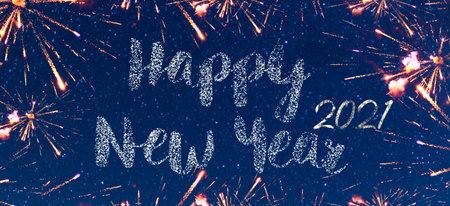 Happy new year 2021 fireworks on a beautiful starry blue sky at night in background. Bright and beautiful fireworks and rockets to welcome and start the year. Christmas celebration, new year's eve.の写真素材