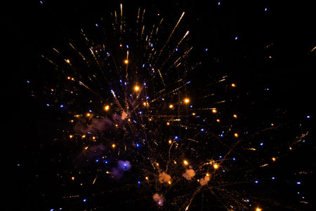 Colorful Fireworks Emitting Sparks - Fireworks at Night with Dark Background. New Years Eve Celebration. Particle Effect, Glowing, Blazing, Twinkling, Glistening.の写真素材