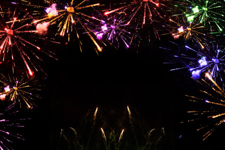 Celebration party with colorful firecrackers, fireworks and rockets isolated in a black background at night. Celebration and new years eve concept.の写真素材