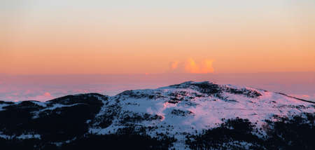 Snowy mountain peak at sunrise or sunset. Calm and relaxing nature mountainous natural scenery....
