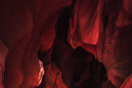 Amazing sandstone formations inside a caves in famous Grand Canyon and Antelope Canyon, USA. Vibrant red colors of eroded rock. Abstract wave forms texture.の写真素材