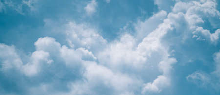 Abstract background of clouds sky with white voluminous foamy air magic clouds in a blue sky. Calm, relax, paradise, heaven, inspiration.の写真素材