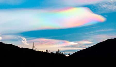 Multicolored rainbow cloud in natural sky background. Unusual and beautiful meteorological...