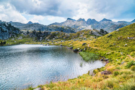 Mountain lake surrounded by mountains. Concept of mountain trip and summer vacations. Circo Saboredo, Aran Valley-Pyrenees, Catalonia, Spain.の写真素材
