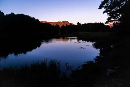 Beautiful sunrise or sunset on an alpine lake in the Pyrenees, Catalonia, Spain. Concept of vacations, summer, relaxation and disconnection in nature. Wilderness.の写真素材