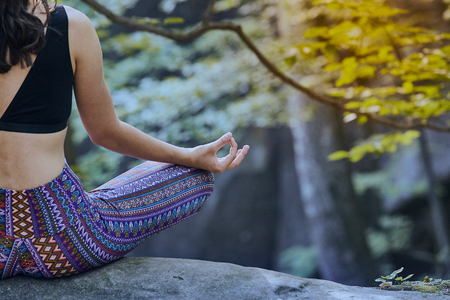 Young girl meditate and doing yoga in forestの写真素材