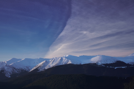 Winter landscape in the mountains at sunset with red sky. Ukraine, Carpathian Mountains, the ridge Chernogoraの写真素材