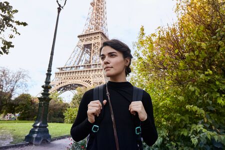 Beautiful smiling girl posing on the background of the Eiffel Tower. Paris, Champ de Marsの写真素材