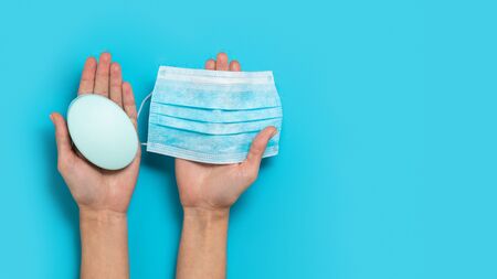 Health care hygiene protection prevention against virus, bacteria, flu and coronavirus by washing hands with soap and wearing mask. Blue background. Coronavirus prevention sanitizer for hand hygiene corona virus protection.の写真素材