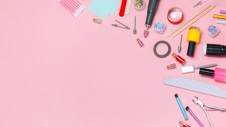 Nail care. A set of professional tools for manicure and pedicure. Beauty care. Coating nails with gel polish. Tools for creating and for the treatment of nails. Salon Banner Pink Backgroundの写真素材