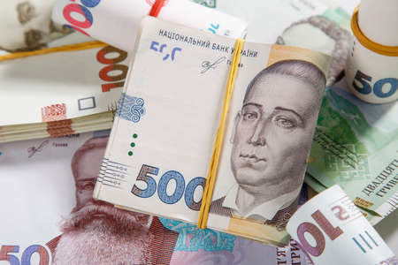 Background from banknotes of the hryvnia. Ukrainian money. A bill in one thousand hryvnia, five hundred and two hundred hryvnia and twenty hryvnia. The banknotes are tightened with an elastic band. Wads of money.のeditorial素材