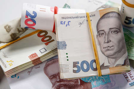 Background from banknotes of the hryvnia. Ukrainian money. A bill in one thousand hryvnia, five hundred and two hundred hryvnia and twenty hryvnia. The banknotes are tightened with an elastic band. Wads of money.のeditorial素材