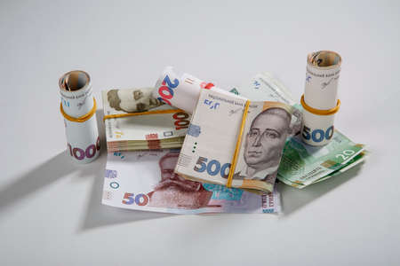 Background from banknotes of the hryvnia. Ukrainian money. A bill in one thousand hryvnia, five hundred and two hundred hryvnia and twenty hryvnia. The banknotes are tightened with an elastic band. Wads of money.のeditorial素材