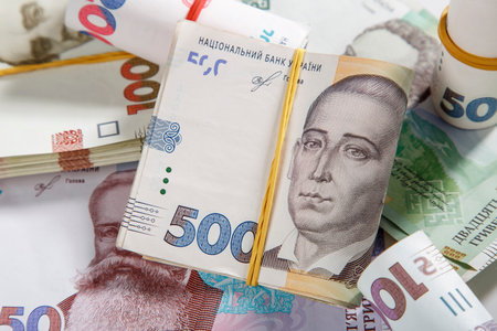 Background from banknotes of the hryvnia. Ukrainian money. A bill in one thousand hryvnia, five hundred and two hundred hryvnia and twenty hryvnia. The banknotes are tightened with an elastic bandの写真素材