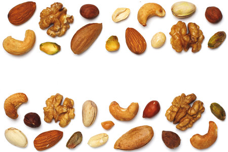 Various nuts isolated on white background. Pecan, macadamia, Brazil nuts, walnuts, almonds, hazelnuts, pistachios, cashews, peanuts, pine nuts. Top view or flat. Copy spaceの写真素材