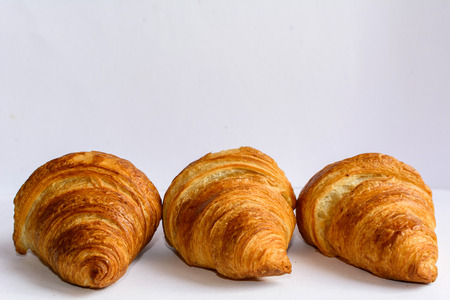 Three croissants on the white background.の写真素材