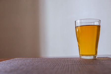 a glass of Apple juice is on the table