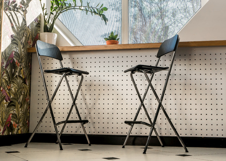 The interior of the cafe. Chairs by the window