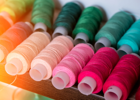 Colored thread in the bobbin. Background for business cards