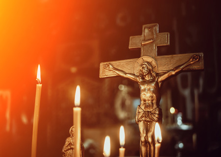 crucifixion in the Church on the background of candles