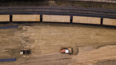 the loader loads the sawdust in the woodworking factory aerial view