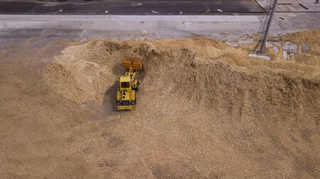 the loader loads the sawdust in the woodworking factory aerial viewの写真素材