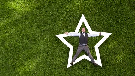 happy presenter with a microphone on the green lawn view from above aerial photography with droneの写真素材