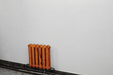 one orange radiator against a gray wallの写真素材