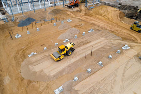 tractor roller ramming the ground for a construction site top view.