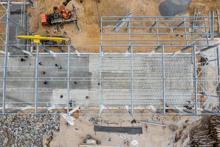 workers fill the concrete floor in the building top view.の写真素材