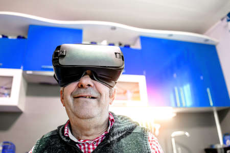 an elderly man wearing virtual reality glasses.の写真素材