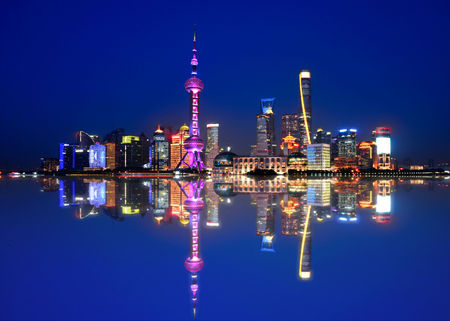 colorful lights and futuristic skyline of skyscrapers and water reflections on river of shanghai pudong skyscrapers, Chinaのeditorial素材