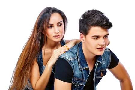 Young romantic couple sitting together and looking at the distanceの写真素材