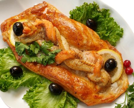 Salad from a salty herring with vegetables and a lemonの写真素材