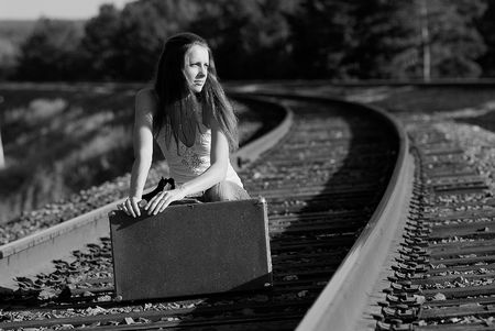 The young woman walks by railの写真素材